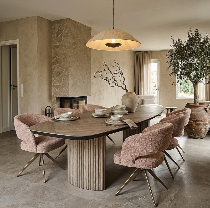 Moderne eettafel Monk met zes zachte roze beklede stoelen en natuurlijke houten afwerking, perfect voor een stijlvolle eetkamer.