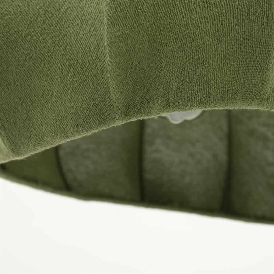 Groene fauteuil bekleding met zachte stof en zwarte piping, close-up detail van meubelstof.