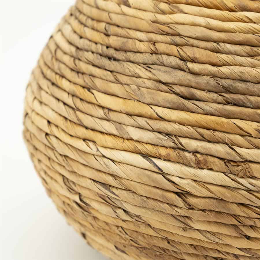 Gezicht op gedetailleerde rieten schaal of mand, gemaakt van natuurlijk gevlochten rietmaterialen voor een rustieke en duurzame uitstraling.