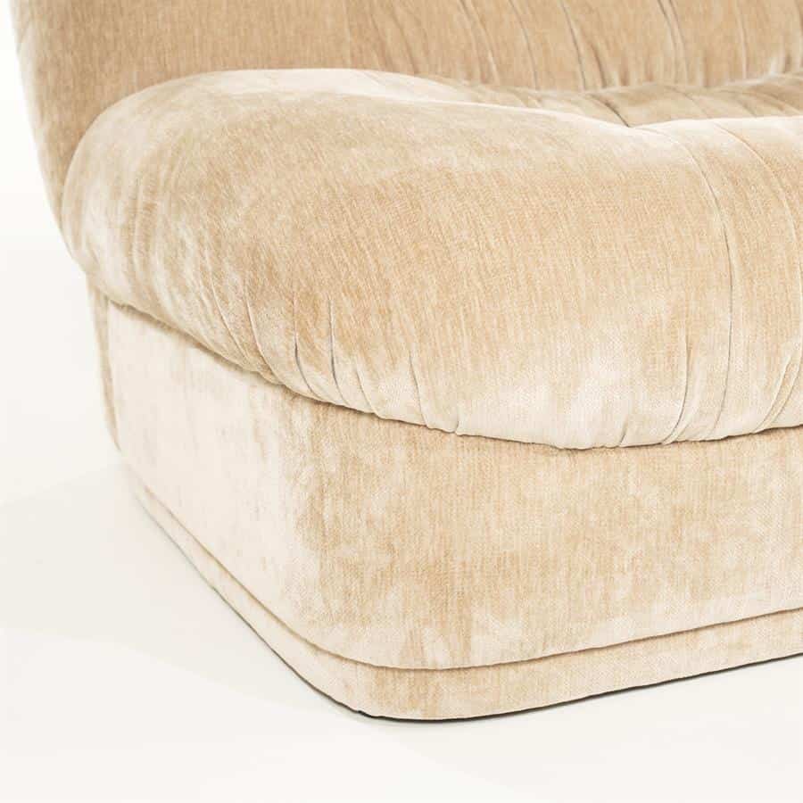Zacht beige velvet fauteuil met comfortabel gestikte zitting en elegante uitstraling, passend in moderne en stijlvolle woonkamers.
