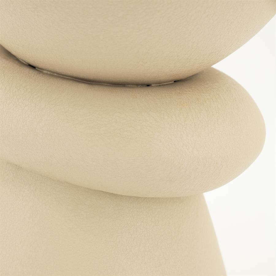 Soft beige textured leather upholstery on modern furniture piece, emphasizing comfort and style.