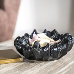 Kandelaar van zwart glanzend porselein op houten tafel, modern design, sfeervolle decoratie, stijlvolle woonaccessoire, Mokana Meubelen, uniek handgemaakt.