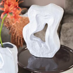Unieke witte kunstzinnige sculptuur op ronde tafel, perfect voor modern interieurdecoratie en luxe woninginrichting. Daarnaast zien we stijlvolle vazen met bloemen, ideaal voor een eigentijdse woonkamer.
