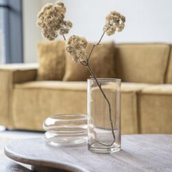 Elegant dried flowers in a minimalist glass vase on a wooden table, styled with modern decor for a cozy living room setting. Perfect for enhancing your interior with natural elements.