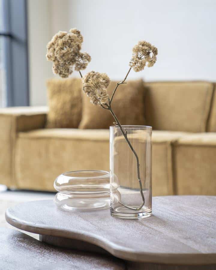 Elegant dried flowers in a minimalist glass vase on a wooden table, styled with modern decor for a cozy living room setting. Perfect for enhancing your interior with natural elements.