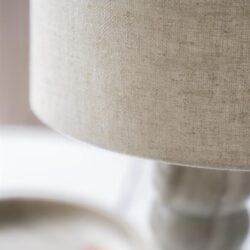 Houten lamp met beige stoffen kap, sfeervolle en stijlvolle woonaccessoire voor een modern interieur.