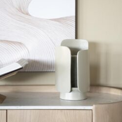 Unieke moderne keramische vaas met strak design op een houten meubel, ideaal voor stijlvolle interieurdecoratie in modern woonruimte.