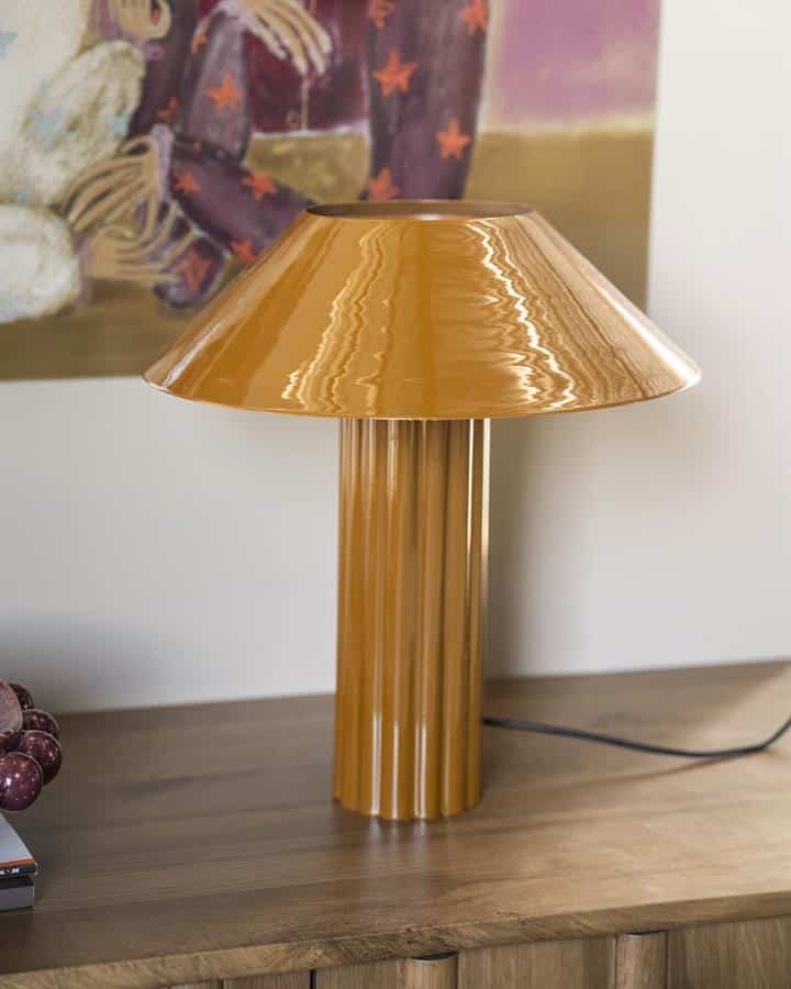 Birne goudkleurige tafel- of bureau lamp, retro design, stijlvol verlichtingselement, unieke decoratie, houten tafel, modern interieur.