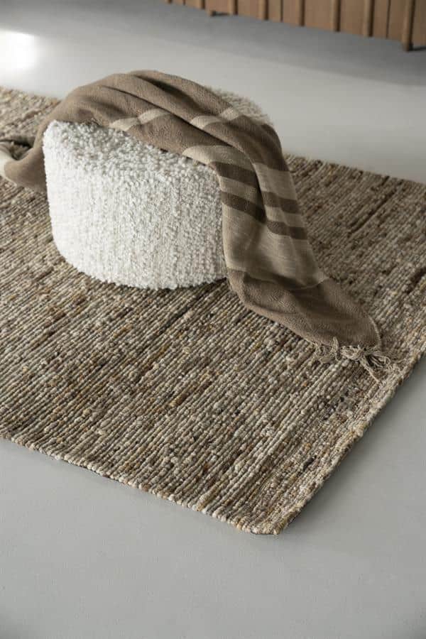 Gevlochten wollen vloerkleed met natuurlijke uitstraling, perfect voor een modern interieur.