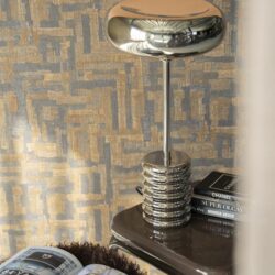 Modern chrome tafel lamp op bijzettafel in interieur, stijlvol decor met design meubels en boeken, perfect voor een luxueus en eigentijds interieurconcept.