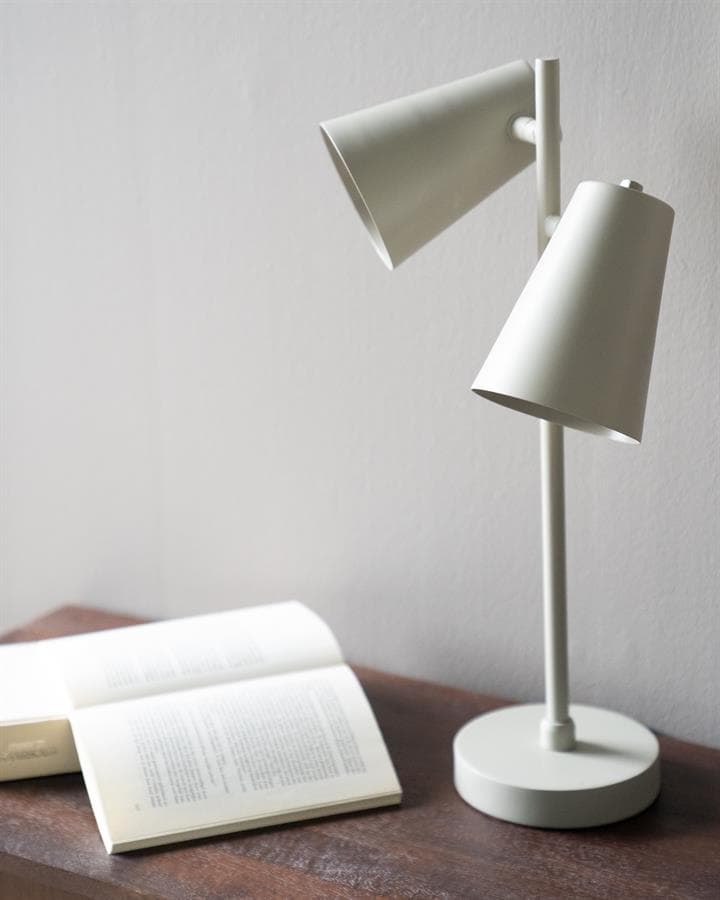 Moderne witte leeslamp op nachtkastje met open boek voor gezellige leeshoek interieur design.