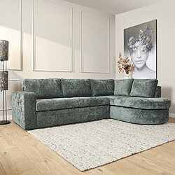 Luxe groene velvet hoekbank in modern interieur met witte wandpanelen en abstract kunstwerk, perfect voor stijlvolle zithoeken en comfort.