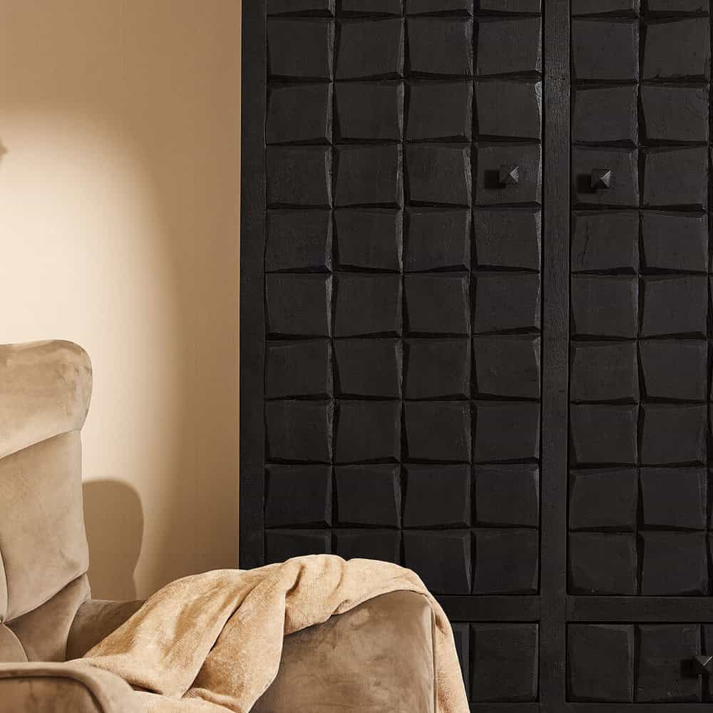 Gelakt zwart uitgesneden kast met opvallend geometrisch patroon en stijlvolle afwerking, perfect voor een modern interieur.