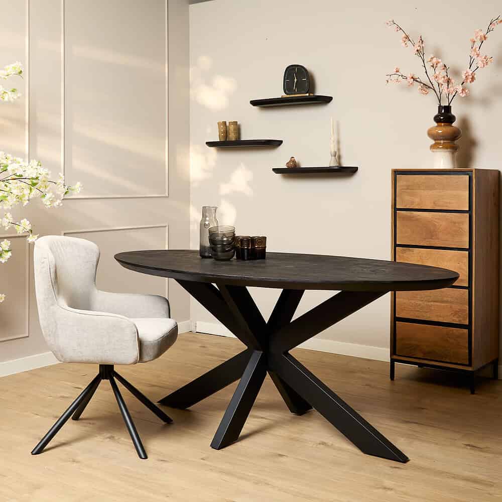 Minimalistisch zwart eettafel met moderne design, gecombineerd met lichte bureaustoel, in een sfeervolle, natuurlijke interior setting met elegante wanddecoraties en decoratieve accessoires.