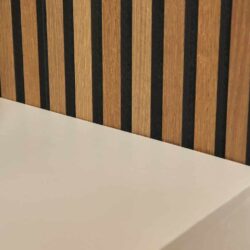 Strak houten wand met verticale zwarte streepaccenten, onderdeel van modern Mokana meubelontwerp, gecombineerd met wit oppervlak voor een eigentijdse uitstraling.