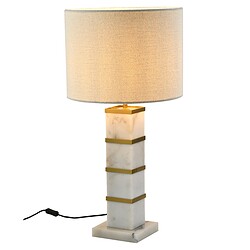 Elegante marmeren tafel- of bureau-lamp met goudkleurige accents en warm verlichte kap, passend bij Mokana meubelen voor een stijlvolle inrichting.