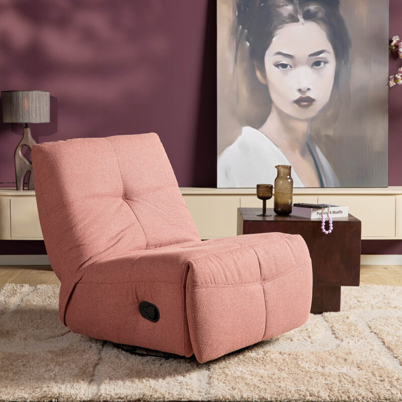 Zithoek in woonkamer met roze relaxfauteuil, stijlvolle woonaccessoires, moderne kunstwerk.