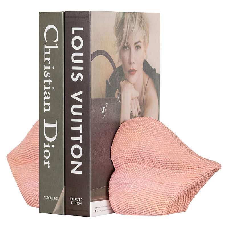 Zachte roze kussens en luxe boeken over Louis Vuitton en Christian Dior, perfect voor stijlvolle interieurdecoratie en comfort. Elegant en trendy accessoire voor moderne woonruimtes.