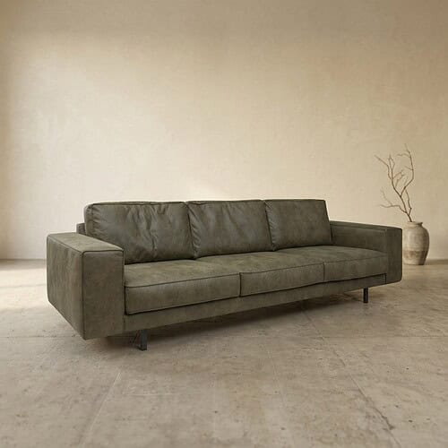 Elegante groene stoffen bank in minimalistisch interieur met een rustige sfeer, perfect voor woonkamer of lounge.