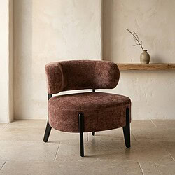 Luxe velvet fauteuil in een warme bruinrode kleur met zwart houten poten, perfect voor een stijlvolle en comfortabele zithoek in elk interieur.