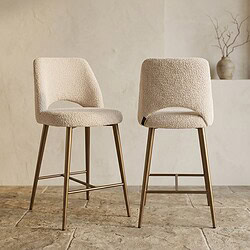 Twee moderne eetkamerstoelen met zachte crème bekleding en goudkleurige poten, perfect voor een stijlvolle en comfortabele eetruimte.