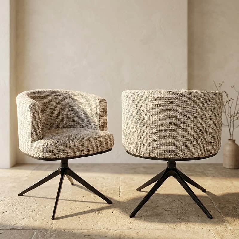 Twee moderne draaistoelen met ronde rugleuning en gestoffeerde zitting, geplaatst op een lichte vloer in een minimalistische interieursetting.