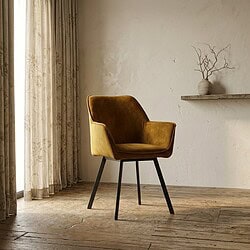 Moderne gele velvet stoel met zwarte poten in een lichte, minimalistische woonkamer met houten vloer en een decoratieve tak in een vaas.