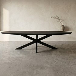 Moderne zwarte eettafel met uniek onderstel in minimalistisch interieur, perfect voor stijlvolle eetkamers en woonruimtes.