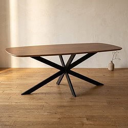 Moderne houten eettafel met zwart metalen onderstel, perfect voor een eigentijdse eetkamer of woonkamer, gecombineerd met natuurlijke en industriële stijlen.