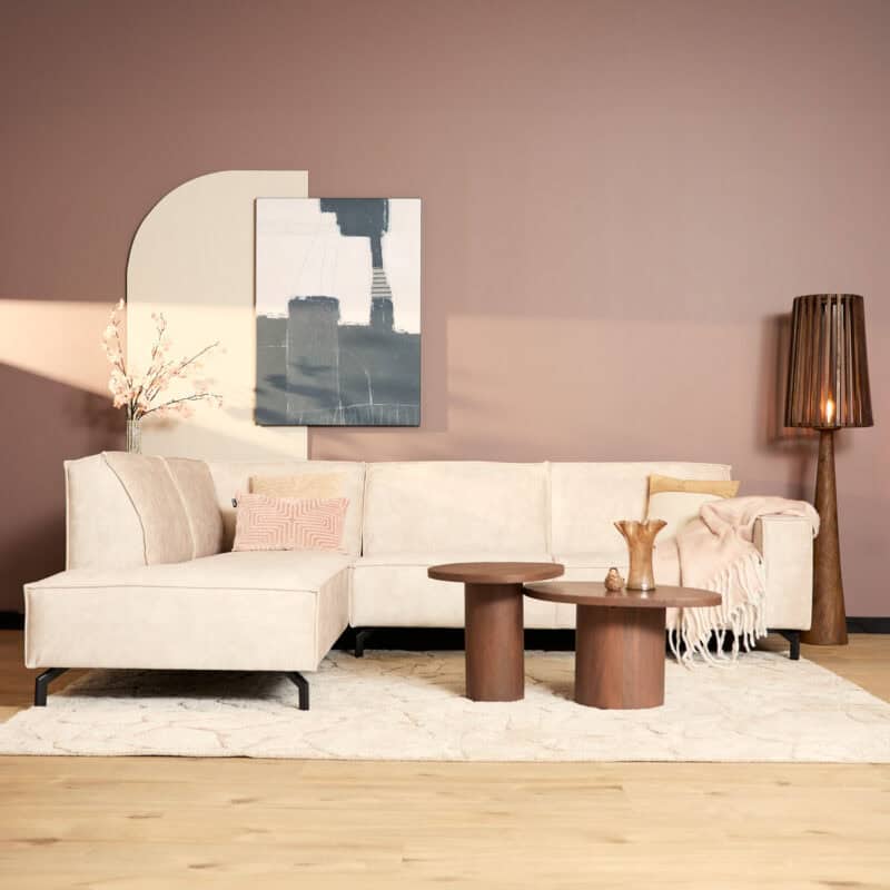 Moderne woonkamer met Mokana meubelen, beige bank, houten salontafels, abstract kunstwerk en stijlvolle lamp, perfect voor een gezellige en stijlvolle inrichting.